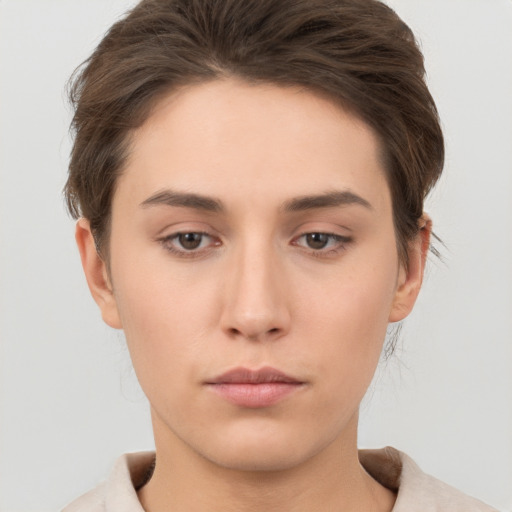 Neutral white young-adult female with short  brown hair and brown eyes