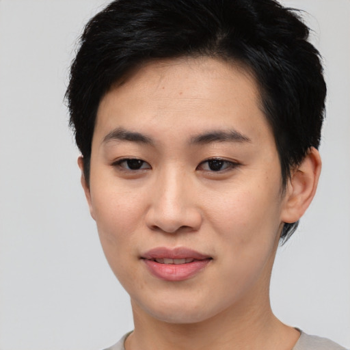 Joyful asian young-adult female with short  black hair and brown eyes