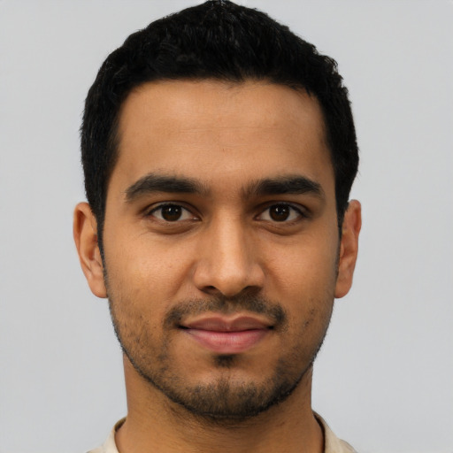 Joyful latino young-adult male with short  black hair and brown eyes