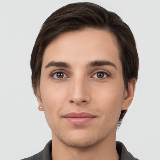 Joyful white young-adult male with short  brown hair and brown eyes