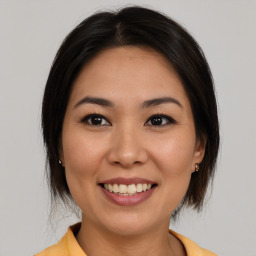 Joyful white young-adult female with medium  brown hair and brown eyes