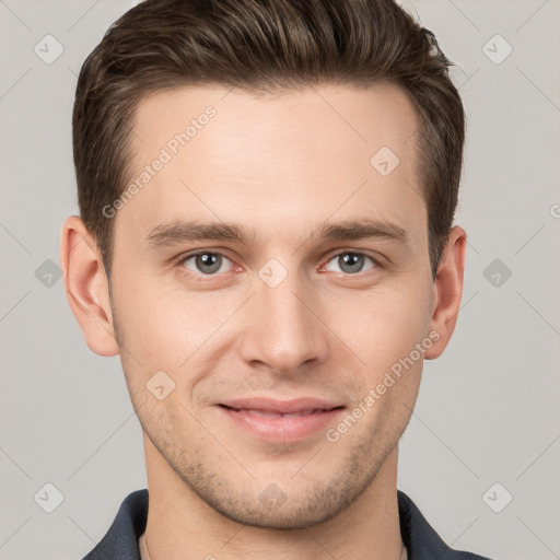 Joyful white young-adult male with short  brown hair and grey eyes