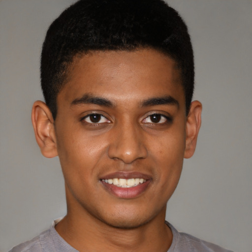 Joyful black young-adult male with short  brown hair and brown eyes