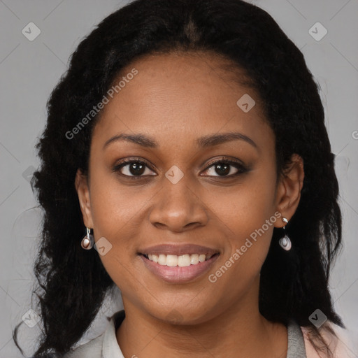 Joyful black young-adult female with long  brown hair and brown eyes