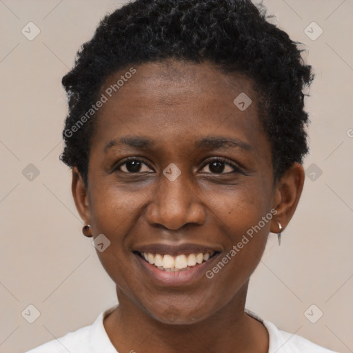 Joyful black young-adult female with short  black hair and brown eyes