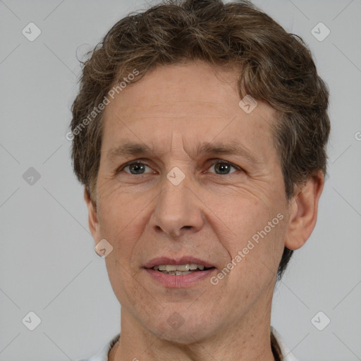 Joyful white middle-aged male with short  brown hair and brown eyes