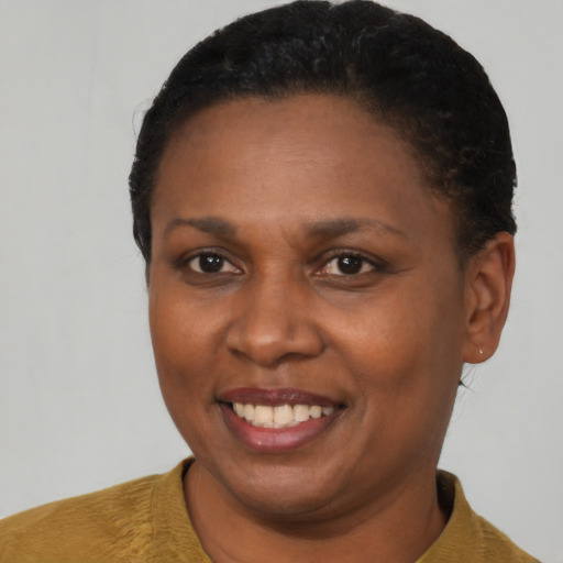 Joyful black young-adult female with short  black hair and brown eyes