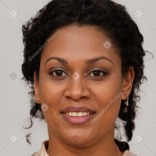 Joyful black adult female with short  brown hair and brown eyes