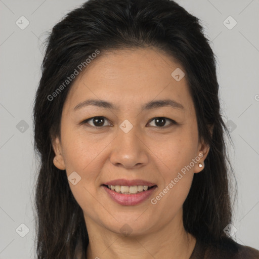 Joyful latino young-adult female with long  brown hair and brown eyes