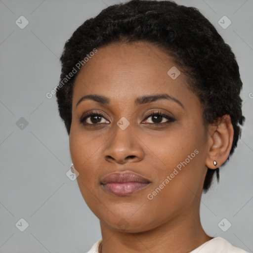 Joyful black young-adult female with short  black hair and brown eyes