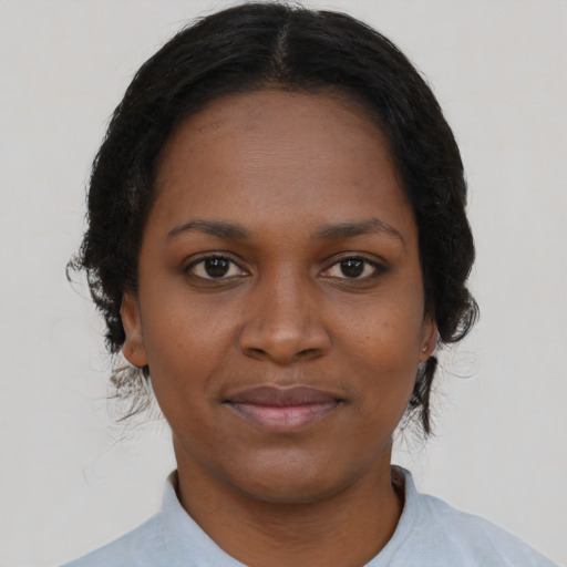 Joyful black young-adult female with short  black hair and brown eyes