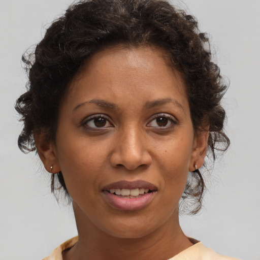 Joyful white adult female with medium  brown hair and brown eyes