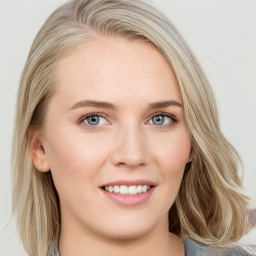 Joyful white young-adult female with medium  brown hair and blue eyes