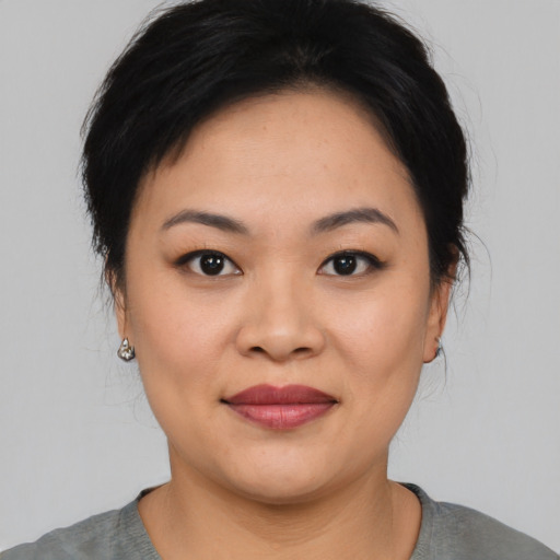 Joyful asian young-adult female with medium  black hair and brown eyes