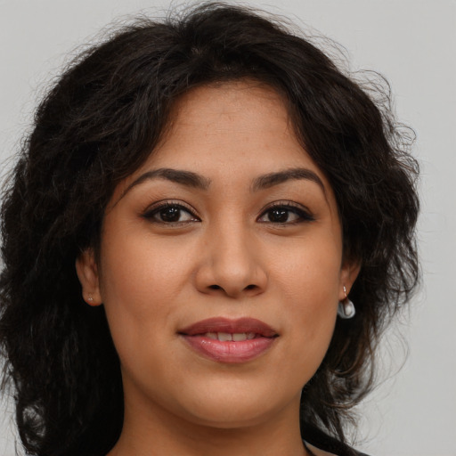 Joyful asian young-adult female with long  brown hair and brown eyes