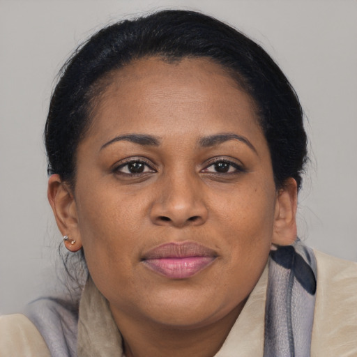 Joyful black young-adult female with medium  brown hair and brown eyes