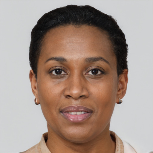 Joyful black adult female with short  brown hair and brown eyes