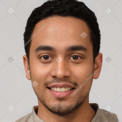 Joyful latino young-adult male with short  black hair and brown eyes