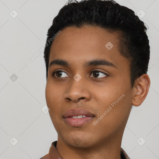 Joyful black young-adult male with short  black hair and brown eyes