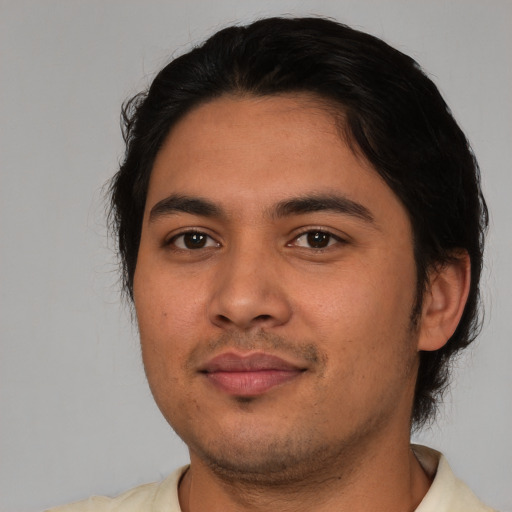 Joyful latino young-adult male with short  black hair and brown eyes