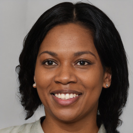 Joyful black young-adult female with medium  black hair and brown eyes
