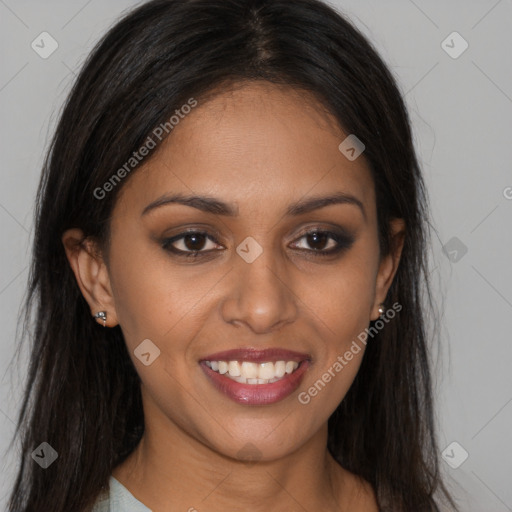 Joyful black young-adult female with long  brown hair and brown eyes