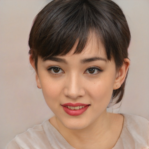 Joyful asian child female with medium  brown hair and brown eyes