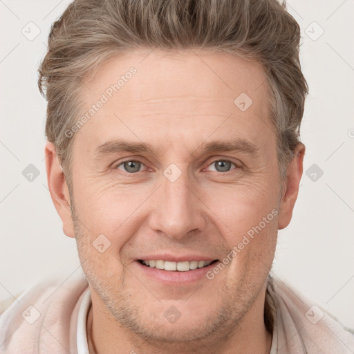 Joyful white adult male with short  brown hair and grey eyes