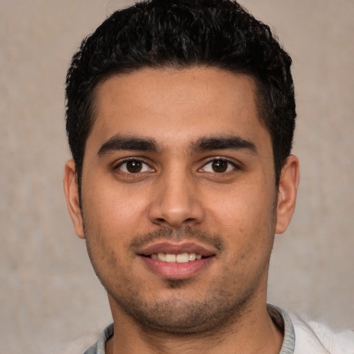 Joyful white young-adult male with short  brown hair and brown eyes