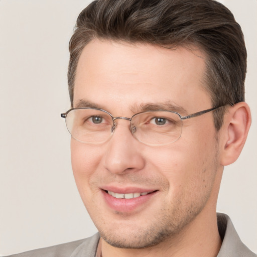 Joyful white adult male with short  brown hair and brown eyes