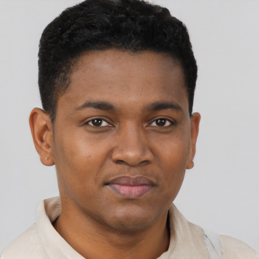 Joyful black young-adult male with short  brown hair and brown eyes