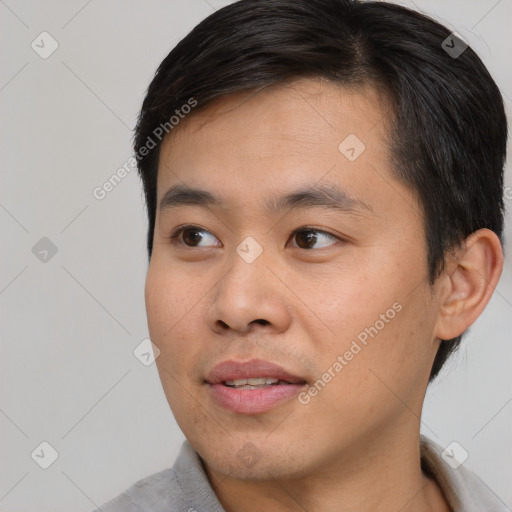 Joyful white young-adult male with short  black hair and brown eyes