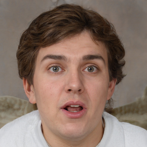 Joyful white adult male with short  brown hair and blue eyes