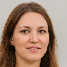 Joyful white young-adult female with long  brown hair and green eyes