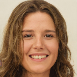 Joyful white young-adult female with long  brown hair and green eyes