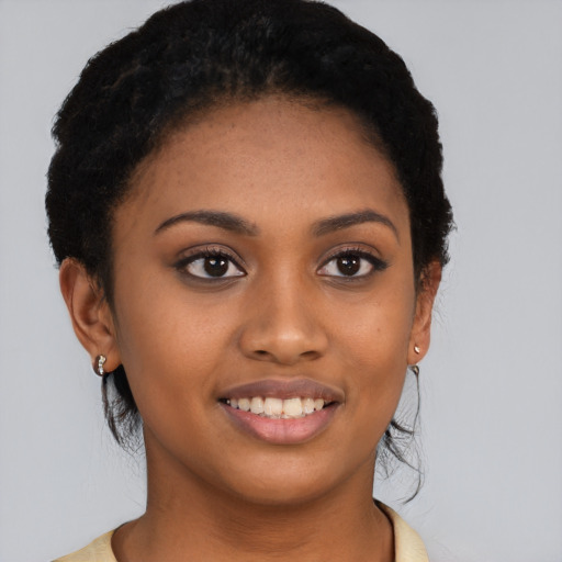Joyful black young-adult female with short  black hair and brown eyes