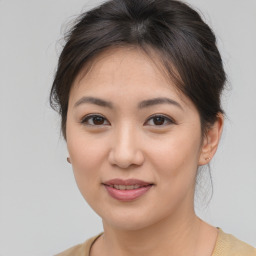 Joyful asian young-adult female with medium  brown hair and brown eyes