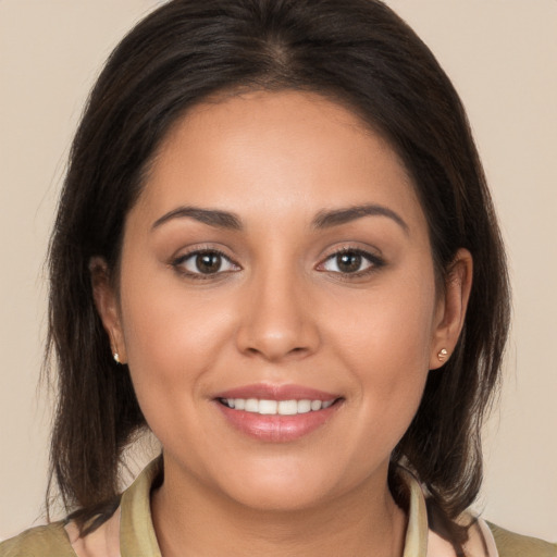 Joyful white young-adult female with long  brown hair and brown eyes