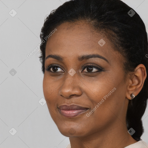 Joyful black young-adult female with short  black hair and brown eyes