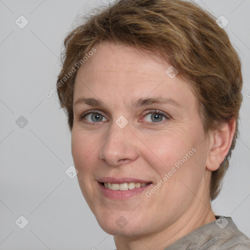 Joyful white adult female with short  brown hair and grey eyes