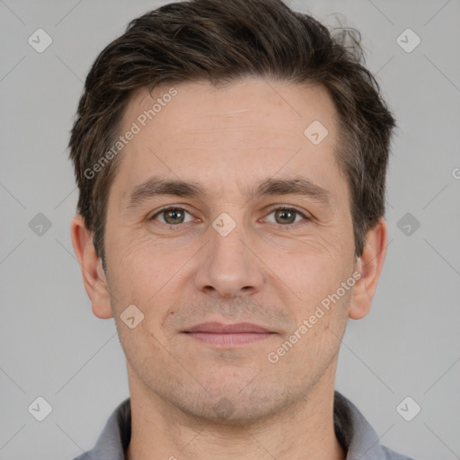 Joyful white adult male with short  brown hair and brown eyes