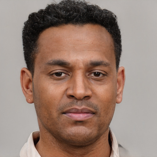 Neutral latino adult male with short  brown hair and brown eyes