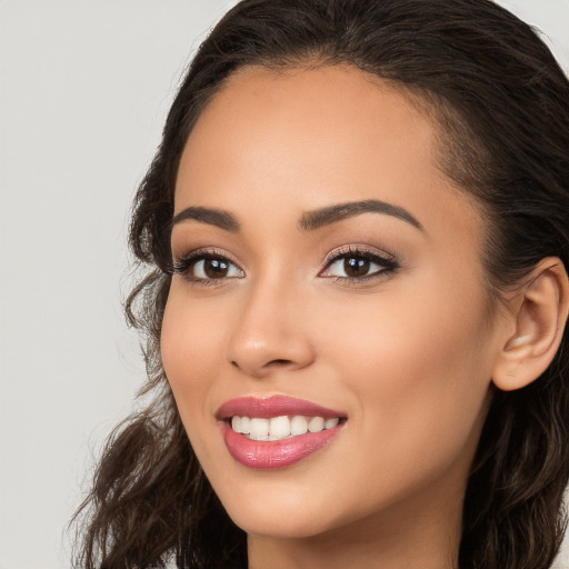 Joyful white young-adult female with long  brown hair and brown eyes