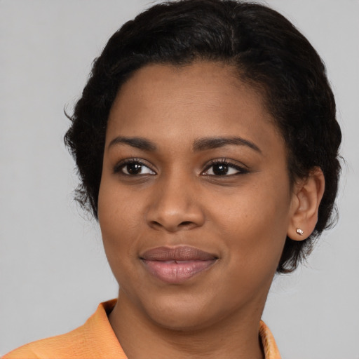 Joyful black young-adult female with medium  brown hair and brown eyes