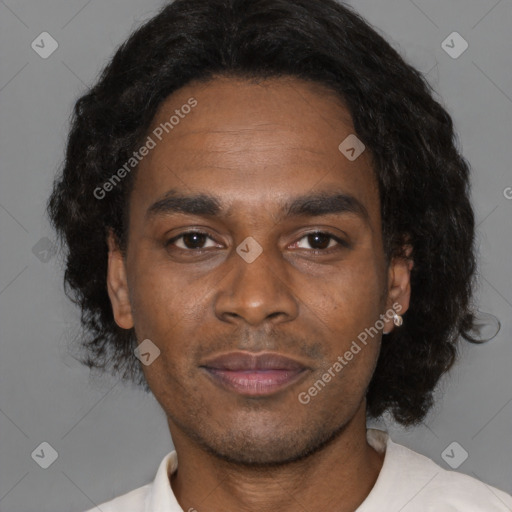 Joyful black young-adult male with short  black hair and brown eyes