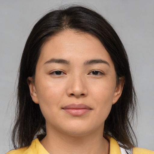 Joyful asian young-adult female with medium  brown hair and brown eyes