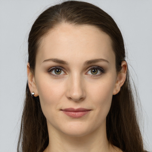 Joyful white young-adult female with long  brown hair and grey eyes