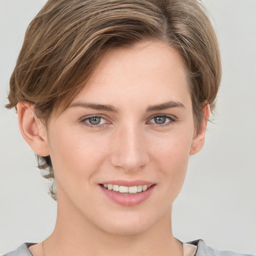 Joyful white young-adult female with medium  brown hair and grey eyes