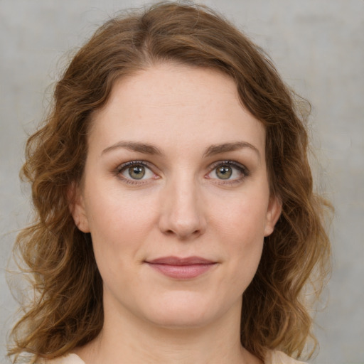 Joyful white young-adult female with medium  brown hair and green eyes