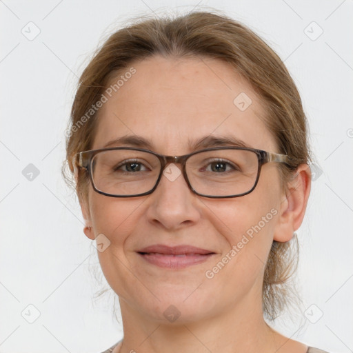 Joyful white adult female with medium  brown hair and grey eyes